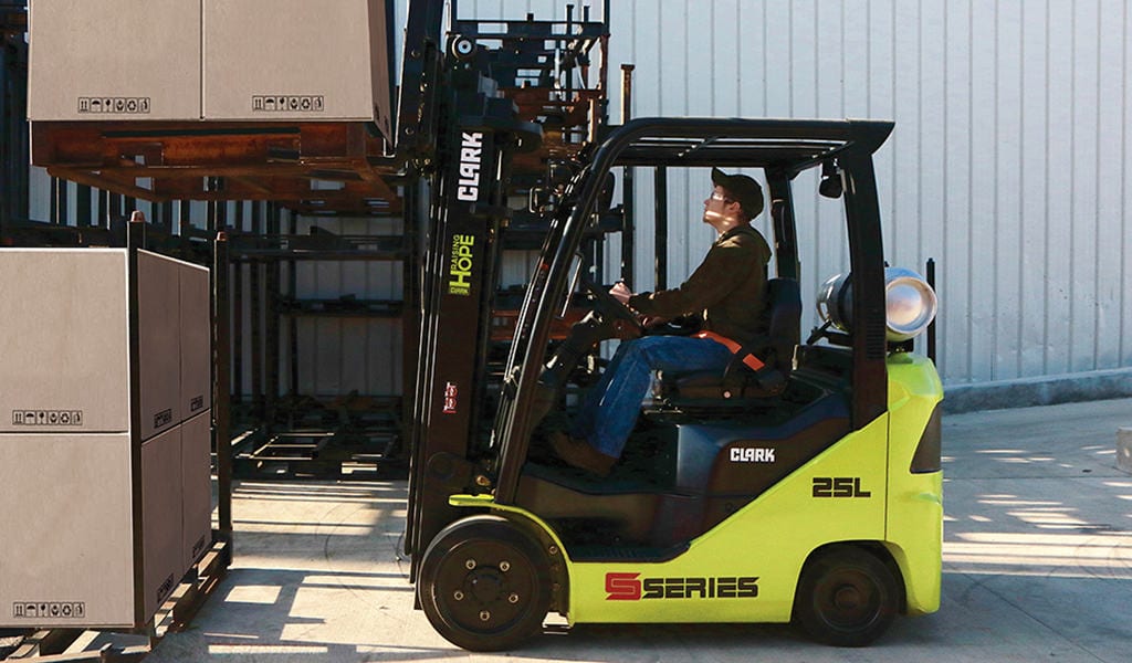 employee uses clark forklift to move boxes